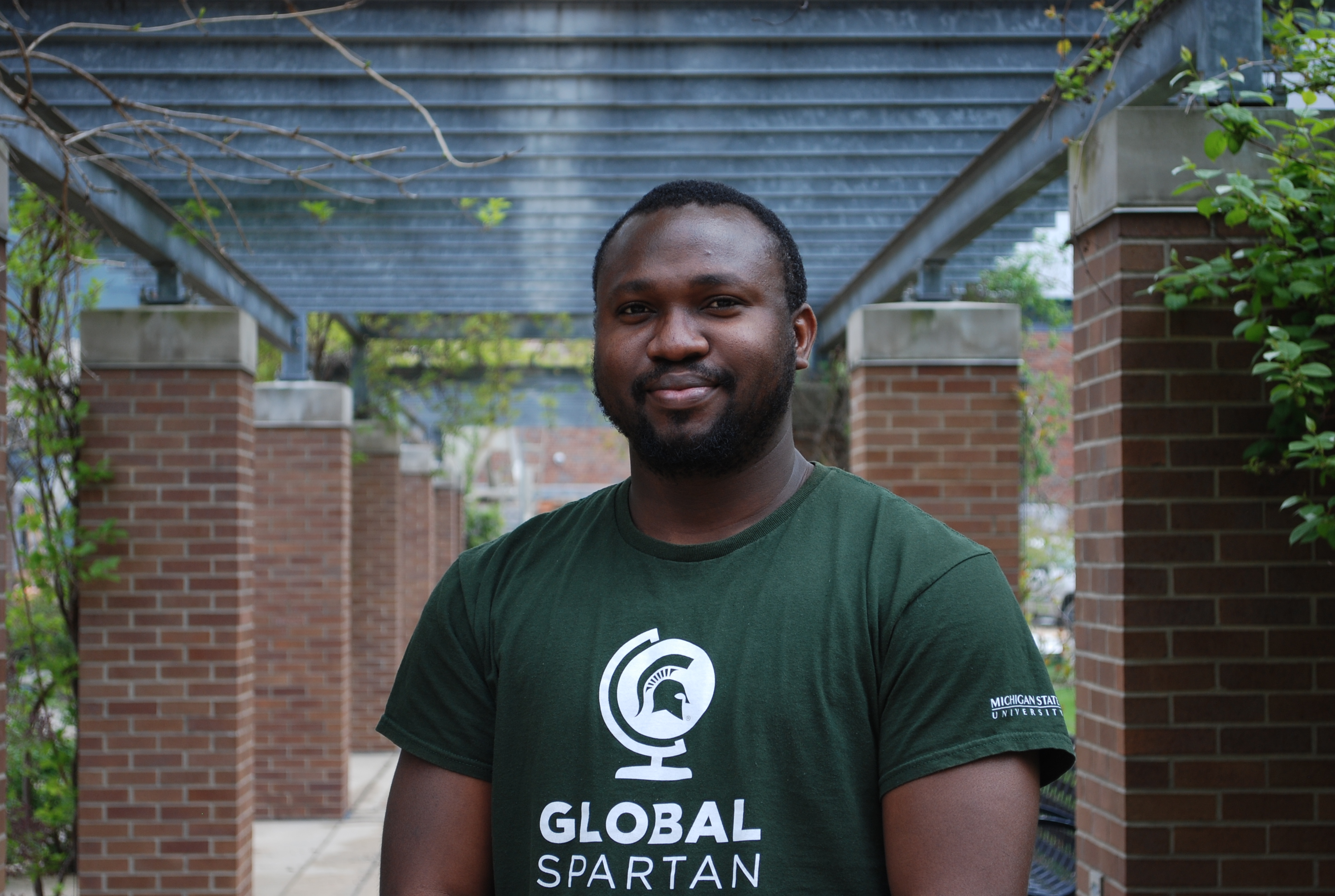Photo of Chinedum in an outdoor covered walkway
