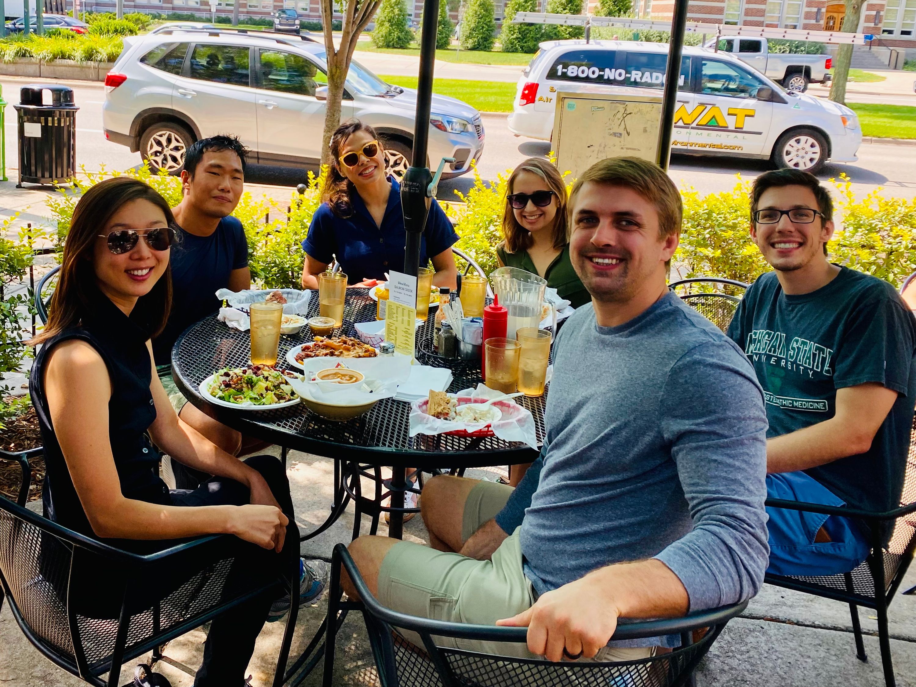 group photo seated at a table on a restaurant patio 2021