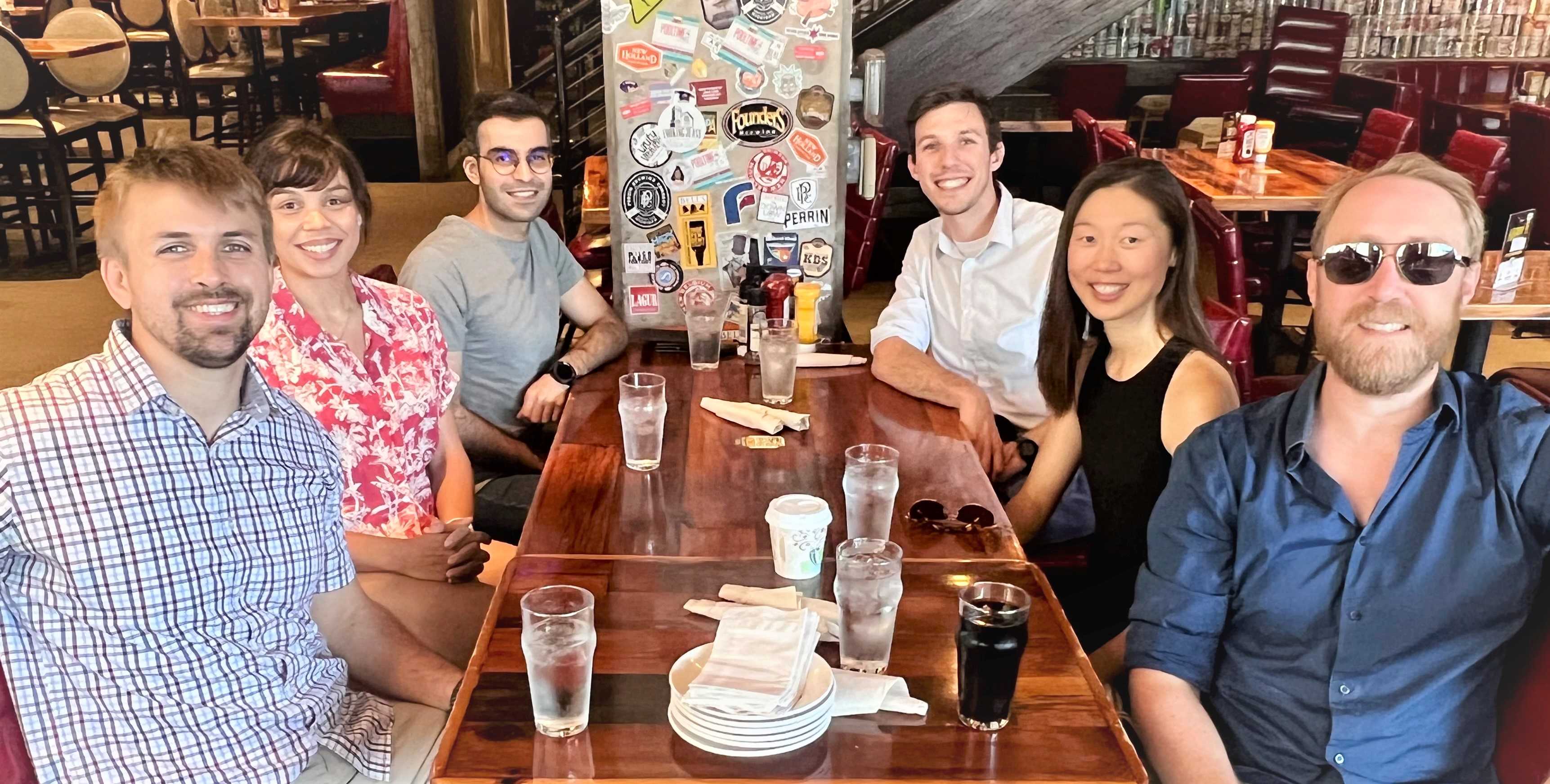 Group photo at a restaurant table