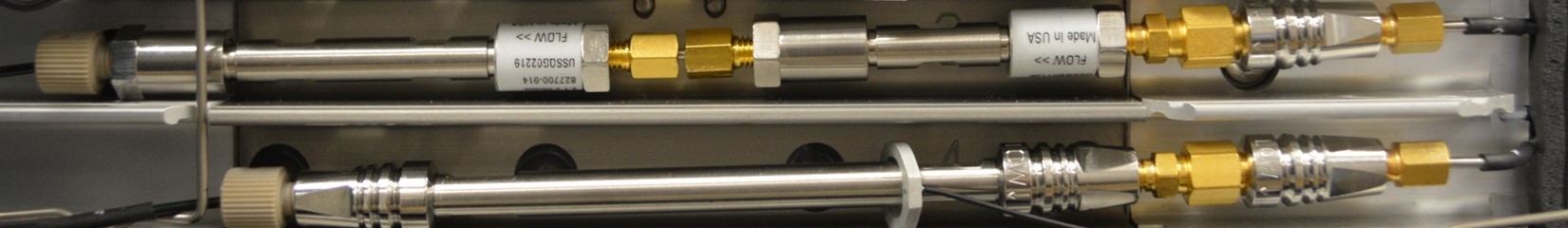 decorative image of metal tubes with brass knobs