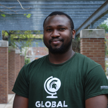 Chinedum Udewku in green spartan shirt.